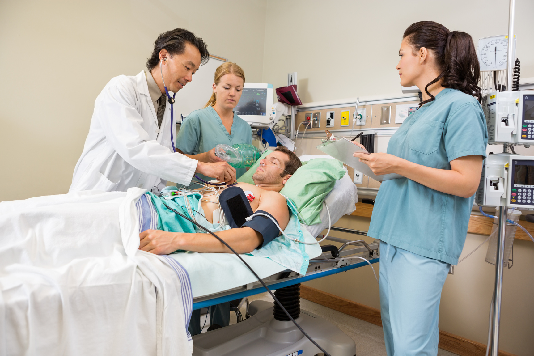 Nurses and Doctor Examining Male Patient
